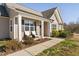 Inviting home featuring a well-maintained front yard, covered porch with seating and tidy landscaping at 16 Eagle Swoop St, Zebulon, NC 27597