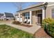 Inviting front porch with a covered entrance, white columns, seating and tidy landscaping at 16 Eagle Swoop St, Zebulon, NC 27597