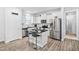 Modern kitchen boasts white cabinets, stainless steel appliances, and a convenient center island at 16 Eagle Swoop St, Zebulon, NC 27597