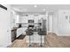 Modern kitchen boasts white cabinets, stainless steel appliances, and a convenient center island at 16 Eagle Swoop St, Zebulon, NC 27597