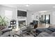 Inviting living room features a fireplace, large TV, and an open flow to dining area at 16 Eagle Swoop St, Zebulon, NC 27597