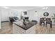 Open-concept living space with stylish furnishings connecting the living and dining areas at 16 Eagle Swoop St, Zebulon, NC 27597