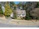An aerial view of a home with large manicured front lawn, mature trees, and two-car garage at 1708 Lakepark Dr, Raleigh, NC 27612