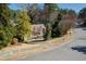 A beautiful aerial view of a home with large manicured front lawn with mature trees and circular driveway at 1708 Lakepark Dr, Raleigh, NC 27612