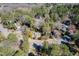 Aerial view of a property surrounded by mature trees in a tranquil neighborhood setting at 1708 Lakepark Dr, Raleigh, NC 27612