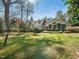 Expansive backyard with mature trees, well-maintained lawn, and landscaping, offering privacy and tranquility at 1708 Lakepark Dr, Raleigh, NC 27612