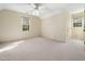 Bright bedroom featuring carpet flooring, two windows, and neutral walls at 1708 Lakepark Dr, Raleigh, NC 27612