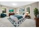 Comfortable bedroom featuring neutral colors, soft carpet, and two windows for natural light at 1708 Lakepark Dr, Raleigh, NC 27612