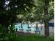 View of the community pool with tables, umbrellas, and chairs at 1708 Lakepark Dr, Raleigh, NC 27612