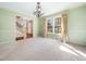 Spacious dining room featuring a chandelier, large windows, and access to other areas of the home at 1708 Lakepark Dr, Raleigh, NC 27612