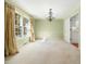 Dining room with carpet, a chandelier, and a big window allowing light at 1708 Lakepark Dr, Raleigh, NC 27612