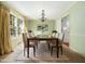 Formal dining room features a large table with seating for eight and modern chandelier at 1708 Lakepark Dr, Raleigh, NC 27612