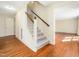 Bright foyer showcasing hardwood floors and staircase, leading to additional rooms at 1708 Lakepark Dr, Raleigh, NC 27612