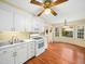 Bright kitchen with white cabinets, modern appliances, and an adjacent dining nook filled with natural light at 1708 Lakepark Dr, Raleigh, NC 27612
