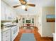 Eat-in kitchen boasts wooden floors, white cabinets, gas range, and bright breakfast nook at 1708 Lakepark Dr, Raleigh, NC 27612