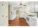 Spacious kitchen featuring white cabinets, modern appliances, and wood-look flooring at 1708 Lakepark Dr, Raleigh, NC 27612