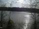 A sunny lake with trees in the foreground at 1708 Lakepark Dr, Raleigh, NC 27612