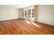 Inviting living room boasts hardwood floors and a large window for abundant sunlight at 1708 Lakepark Dr, Raleigh, NC 27612