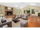 Spacious living area with a fireplace, skylights, and a comfortable seating arrangement at 1708 Lakepark Dr, Raleigh, NC 27612