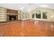 Open living room with fireplace, built-in bookshelves, and large windows for abundant natural light at 1708 Lakepark Dr, Raleigh, NC 27612