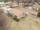Aerial shot of the home showcasing a detached garage and outbuilding, highlighting its expansive grounds at 1723 Bahama Rd, Bahama, NC 27503