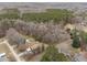 Aerial view of a wooded neighborhood with single-Gathering homes, driveways, and a winding two-lane road through the area at 1723 Bahama Rd, Bahama, NC 27503