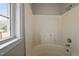 This bathroom has a tub with tile surround and a bright window at 1723 Bahama Rd, Bahama, NC 27503