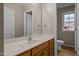 Bright bathroom featuring a marble countertop, wooden cabinets, and a view from the window at 1723 Bahama Rd, Bahama, NC 27503