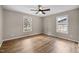 Bright bedroom with wood floors featuring neutral paint and several windows at 1723 Bahama Rd, Bahama, NC 27503