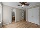 This bedroom has a ceiling fan, closet, ensuite bathroom and wood-look flooring at 1723 Bahama Rd, Bahama, NC 27503