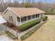 Well-maintained house featuring a covered porch, neat landscaping, and classic architectural details at 1723 Bahama Rd, Bahama, NC 27503