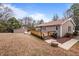 Rear view of the home, including a deck and outbuilding, showcasing the property's layout at 1723 Bahama Rd, Bahama, NC 27503
