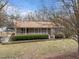 Elevated view of a home featuring a spacious front porch, landscaping, and driveway at 1723 Bahama Rd, Bahama, NC 27503