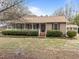 Charming single-story home featuring a welcoming front porch and well-maintained landscaping at 1723 Bahama Rd, Bahama, NC 27503