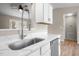 Close up of modern kitchen sink, white cabinetry, stainless appliances and fixtures at 1723 Bahama Rd, Bahama, NC 27503