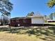 View of the backyard of a brick home with an open grass area at 1723 Lynne Ave, Henderson, NC 27536