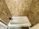 Bathroom featuring white bathtub with tile surround at 1723 Lynne Ave, Henderson, NC 27536