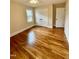 Bedroom featuring refinished wood flooring and neutral paint with closet at 1723 Lynne Ave, Henderson, NC 27536