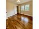Bedroom showcasing hardwood floors, a closet, and natural light from a window at 1723 Lynne Ave, Henderson, NC 27536