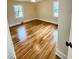 Bright bedroom featuring hardwood floors and natural light from two windows at 1723 Lynne Ave, Henderson, NC 27536