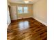 Bedroom showcasing hardwood floors, a closet, and natural light from a window at 1723 Lynne Ave, Henderson, NC 27536