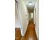 Hallway with beautiful hardwood floors and access to bathroom and other rooms at 1723 Lynne Ave, Henderson, NC 27536