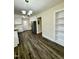 Spacious kitchen with stainless appliances, white cabinetry, granite countertops, and modern dark wood flooring at 1723 Lynne Ave, Henderson, NC 27536