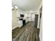 Updated kitchen featuring stainless steel appliances, white cabinets, granite countertops, and dark wood flooring at 1723 Lynne Ave, Henderson, NC 27536