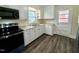Bright kitchen with stainless appliances, white cabinets, granite countertops, and modern flooring at 1723 Lynne Ave, Henderson, NC 27536