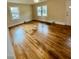 Light filled living room with refinished wood flooring at 1723 Lynne Ave, Henderson, NC 27536