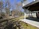 Expansive backyard featuring a stone patio, lush green lawn, and mature trees at 1816 Phillips Dr, Sanford, NC 27330