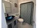 Bathroom featuring a vessel sink, grey vanity, and a shower with decorative curtain at 1816 Phillips Dr, Sanford, NC 27330