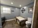 Bathroom featuring a soaking tub with stone accents and slate tile floors at 1816 Phillips Dr, Sanford, NC 27330