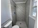 Nicely tiled bathroom shower with grey wood-like tiling and mosaic flooring at 1816 Phillips Dr, Sanford, NC 27330